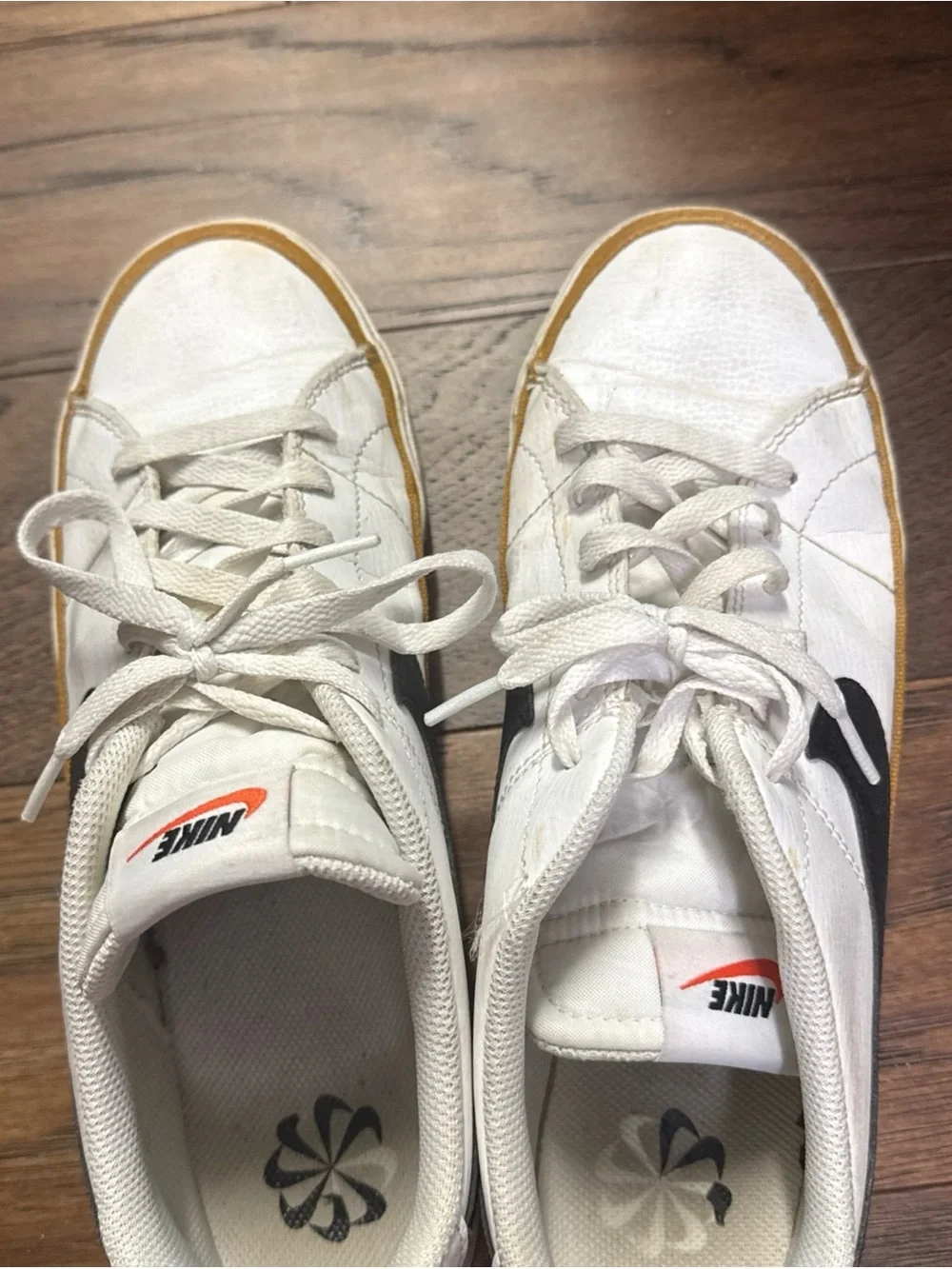 Nike White Low-Top Sneakers with Black Swoosh and Brown Trim